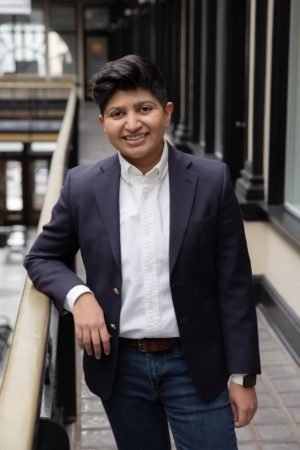 A photograph of Zainab Saleh, dressed in a blazer and smiling.