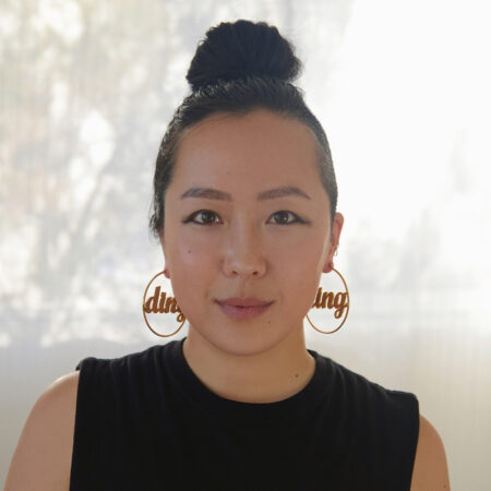 A photograph of Sue Ding, an East Asian woman wearing black shirt.