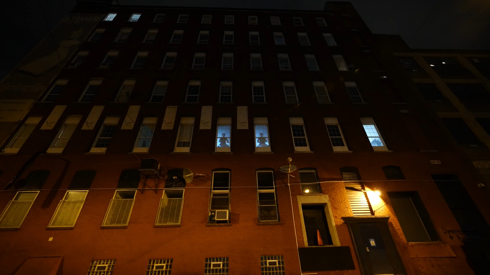 Rob Cosgrove, Broadcast presence (2021). Two silhouettes of drummers illuminated in windows of a building at night.