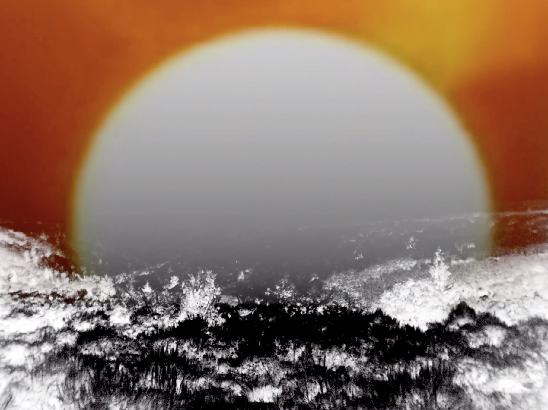 A still from Jason Livingston's film Ancient Sunshine. A white round sun fills the image. On the top and middle around it are yellow, orange, and red fields, and on the bottom, are black and white textures that cut off the bottom of the sun.